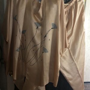 A beautiful gold, silver and black pants suit.